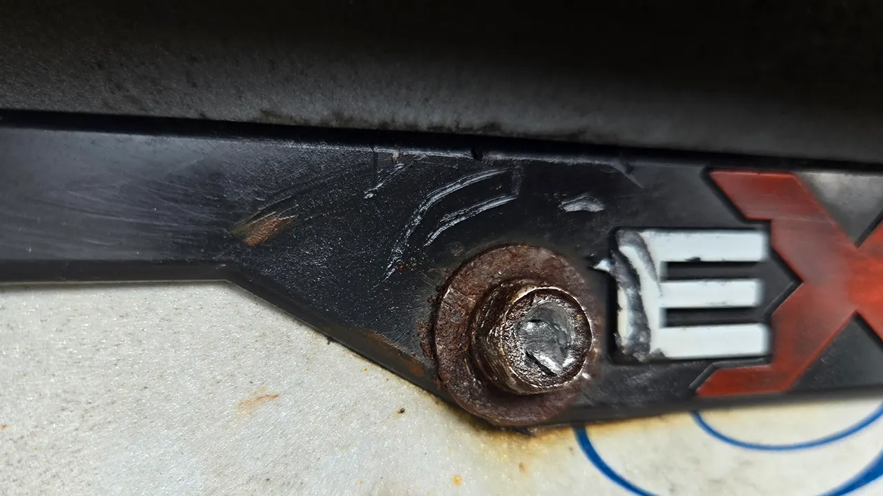 how to remove seized license plate frame screws